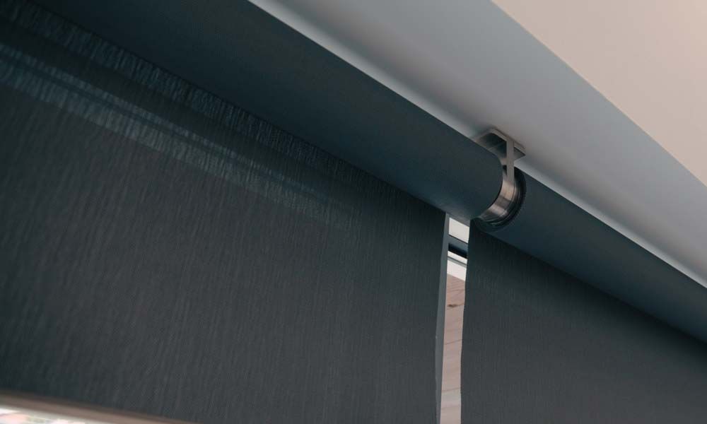 Close-up of sleek roller shades in a modern space, providing elegant light control.