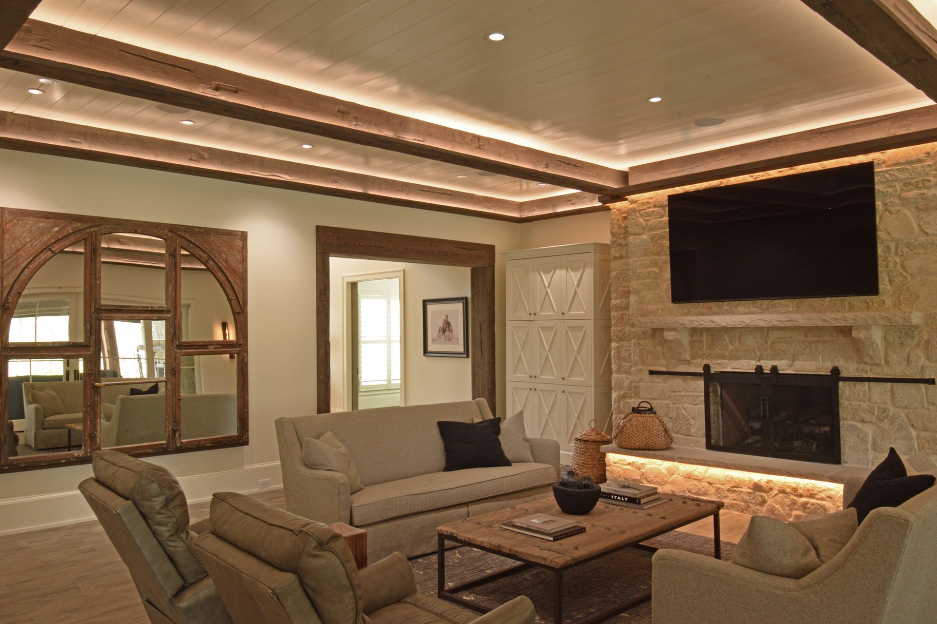 Cozy living room with layered lighting and a warm glow.